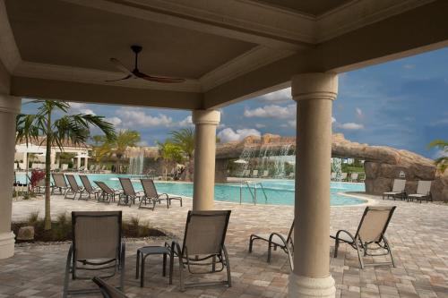 een groep stoelen en een zwembad in een resort bij Luxurious 2 bed 2 bath condo Golf Community in Bradenton