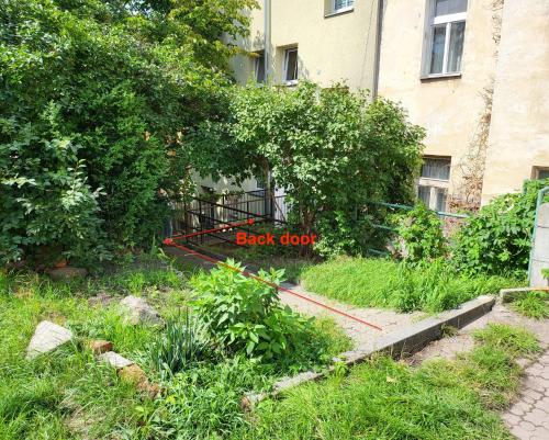 a garden with a sign that says back door at Excellent apartments in Spa City Center 5 min walk from the Colonnade in Karlovy Vary