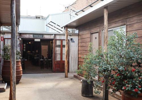 an open door of a building with potted plants at The Staging Post in Longreach