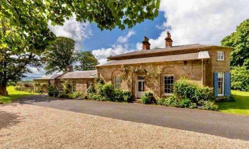 an old stone house with a driveway in front of it at Private room & bathroom in Manor House in Maybole