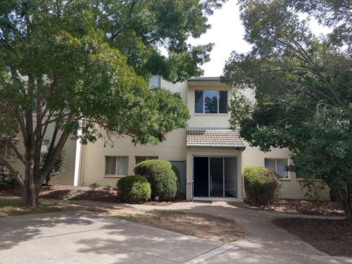 a white house with a driveway in front of it at Beautiful Outlook, nr Canberra Hospital @Woden in Phillip