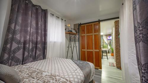 a bedroom with a bed and a window and a camera at Arenal Tiny Houses - STAR in Fortuna