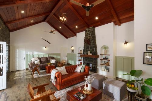 a living room with a couch and a fireplace at 31st December Farms And Estates Munnar in Munnar