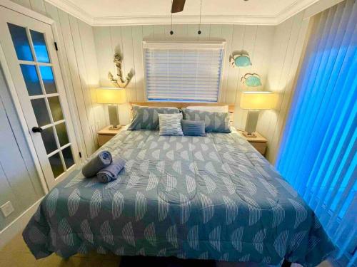 1 dormitorio con 1 cama con edredón azul en Mango’s House Close to Beach…Pool, Table Pool en Pompano Beach