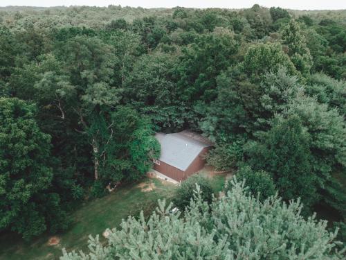an aerial view of a barn in the middle of a forest at Great Frontier Cabin at American Heartland Cabins in Rockbridge
