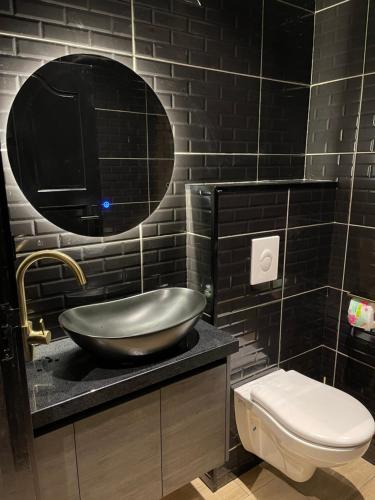 a bathroom with a bowl sink and a toilet at Boa vista appartementen in Paramaribo