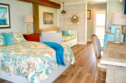 a bedroom with a bed and a desk and a table at Waterfront Guesthouse on Key Allegro/Little Bay with dock in Rockport