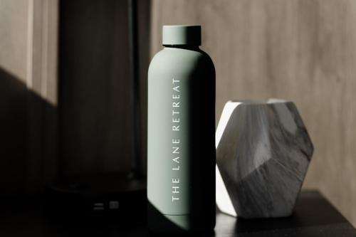 a bottle of shampoo sitting next to a container at The Lane Retreat in Pokolbin