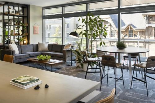a living room with a couch and a table at Hotel Vance, Portland, a Tribute Portfolio Hotel in Portland