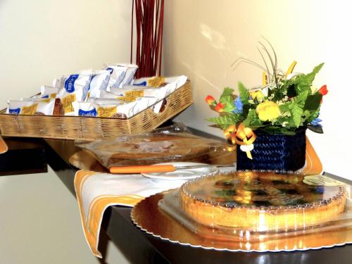 a table with a cake and some food on it at Il Piccolo Golf in Muggiò