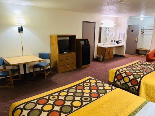 a hotel room with two beds and a television at Super 8 by Wyndham Hot Springs in Hot Springs