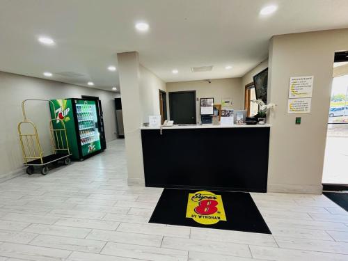 a store lobby with a drink machine and a rug at Super 8 by Wyndham Hot Springs in Hot Springs