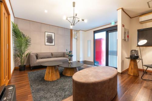 a living room with a couch and a table at Namba Enpuku in Osaka