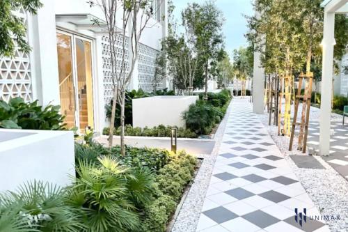 a garden with a checkered sidewalk and plants at UNA Sunway Velocity Kuala Lumpur by Unimax in Kuala Lumpur