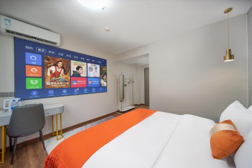 a bedroom with a large bed and a large screen at Guangzhou Yashay International Apartment - Pazhou Convention and Exhibition Centre in Guangzhou