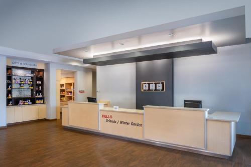 a waiting area in a pharmacy with a pharmacy counter at TownePlace Suites Orlando at FLAMINGO CROSSINGS® Town Center/Western Entrance in Orlando