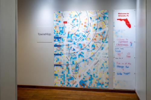 a wall with a painting with a map on it at TownePlace Suites Orlando at FLAMINGO CROSSINGS® Town Center/Western Entrance in Orlando