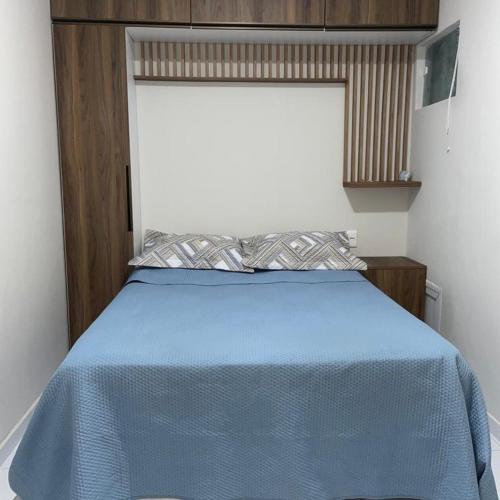 a bed in a room with a blue blanket on it at Rsolmar2023 in Tamandaré