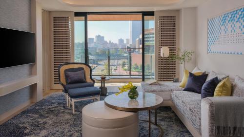 a living room with a couch and a large window at InterContinental Yokohama Pier 8, an IHG Hotel in Yokohama