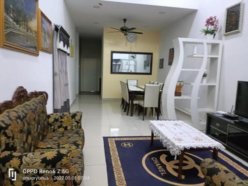 a living room with a couch and a table at Nurkasih Homestay Jerantut in Jerantut