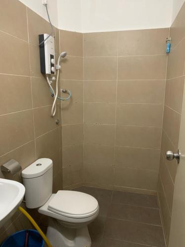 a bathroom with a toilet and a sink at Nurkasih Homestay Jerantut in Jerantut