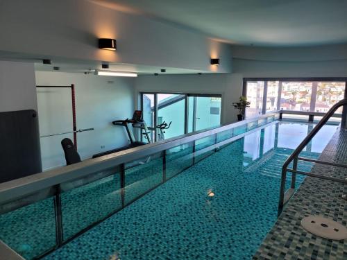 a swimming pool in a building with a swimming pool at Tory Hotel in Wellington