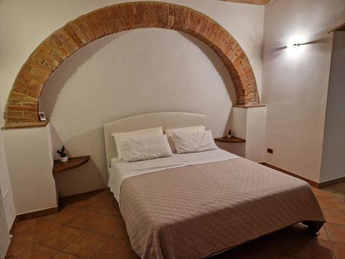 una camera da letto con un letto ad arco sopra di esso di Agriturismo Montepinci a Montalcino