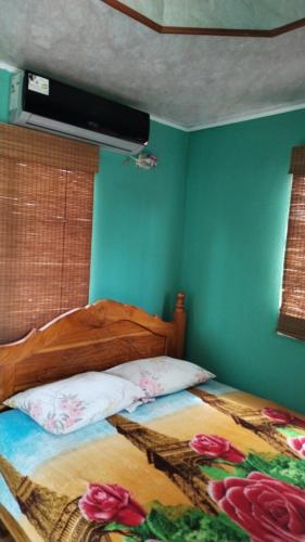 a bedroom with a wooden bed with flowers on it at Finca Agroturistica Villaverde in Nuevo Chagres