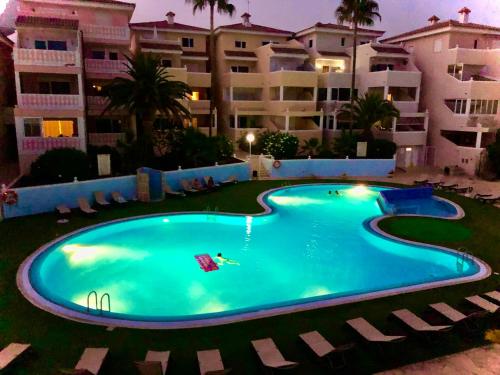 a large swimming pool in front of a building at La Perla del Sur - The Pearl House in Chayofa