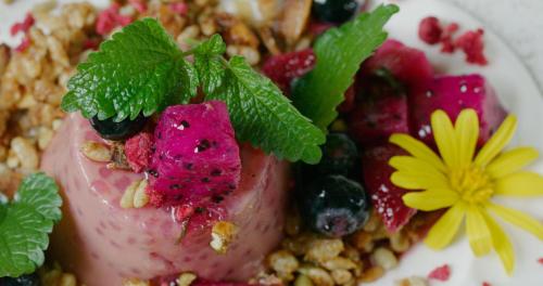 a dessert with fruit and nuts on a plate at Essence Peregian Beach in Peregian Beach