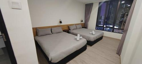 En eller flere senge i et værelse på Secret Garden @ Cameron Centrum