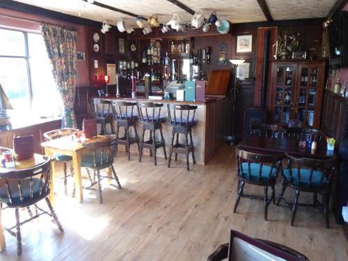 a bar in a restaurant with tables and chairs at Kylemore Pass Hotel in Letterfrack