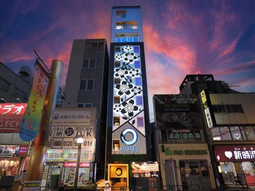a tall building in a city with many buildings at Hotel Opera in Tokyo