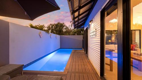a swimming pool in the backyard of a house at The Pearle of Cable Beach in Broome