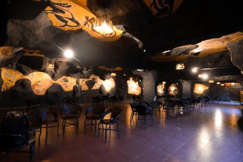 a group of chairs in a room with a stone wall at MJ Avyanna Resort & Convention Centre, Bengaluru in Bengaluru