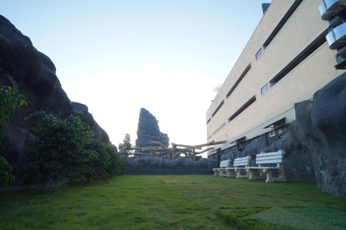 a row of white benches in front of a building at MJ Avyanna Resort & Convention Centre, Bengaluru in Bengaluru