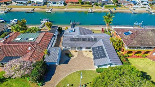 uma vista aérea de uma casa com painéis solares nos seus telhados em Hibbard Waterfront Escape em Port Macquarie
