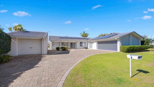 a house with a driveway in a yard at Hibbard Waterfront Escape in Port Macquarie