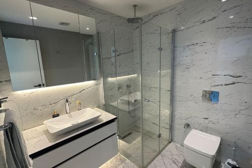 a bathroom with a sink and a glass shower at Ultra luxurious 1Bd,High floor,with balcony in Istanbul