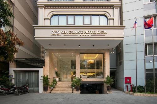 a building with a sign on the front of it at Sen Grand Hotel & Spa managed by Sen Group in Hanoi