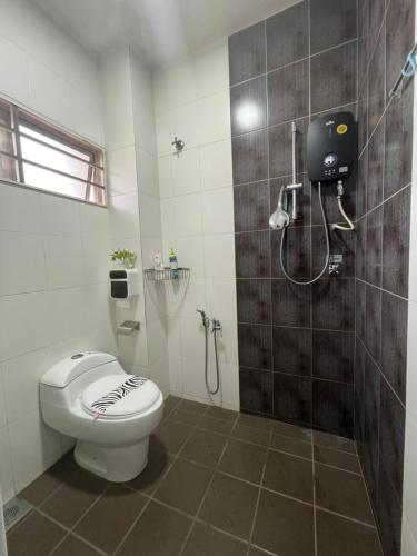 a bathroom with a toilet and a shower at Double storey and half 4r3b karaoke lami in Cheras
