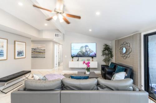 a living room with a couch and a ceiling fan at Disneyland Dream Villa 5 BR 3 BA Arcade Games in Anaheim