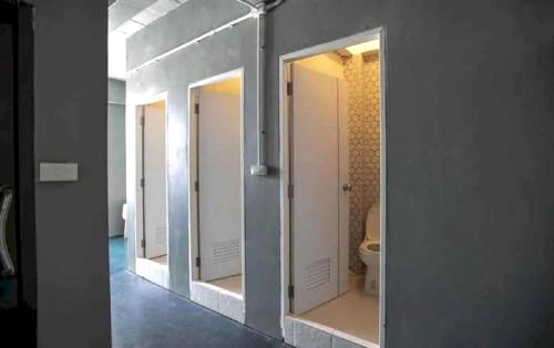 una fila di specchi in un bagno con servizi igienici di OYO 75440 Nara Hostel a Bangkok