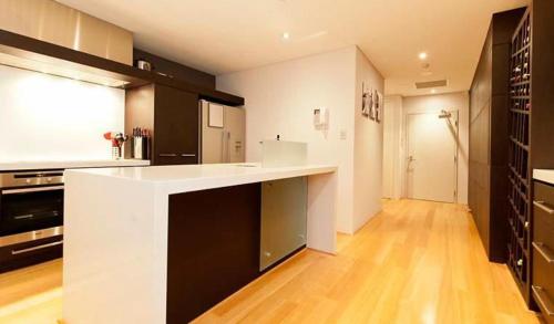 a large kitchen with a white and black counter top at 47 Breathtaking City Riverviews 2brpark in Perth