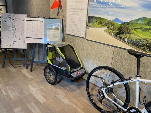 a small car is parked next to a bike at Kona Stay Bicycle Resort in Izunokuni