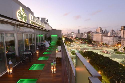 a balcony of a building with green lights on it at Eurobuilding Hotel Boutique Buenos Aires in Buenos Aires
