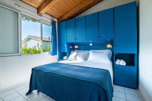 En eller flere senge i et værelse på Numanablu Resort Sport Fun Kids 4 stelle