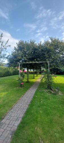 a garden with a pavilion in a grass field at Guesthouse Claeswael in Klaaswaal