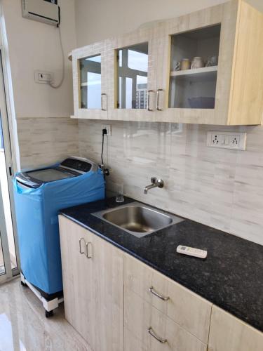 a kitchen with a sink and a trash can at Vista Vibes in Chennai