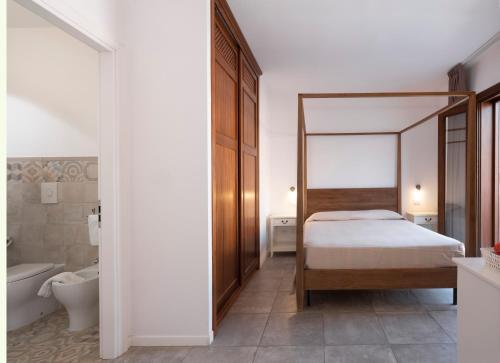 a bedroom with a bed and a toilet and a sink at Moresco Resort in Lampedusa